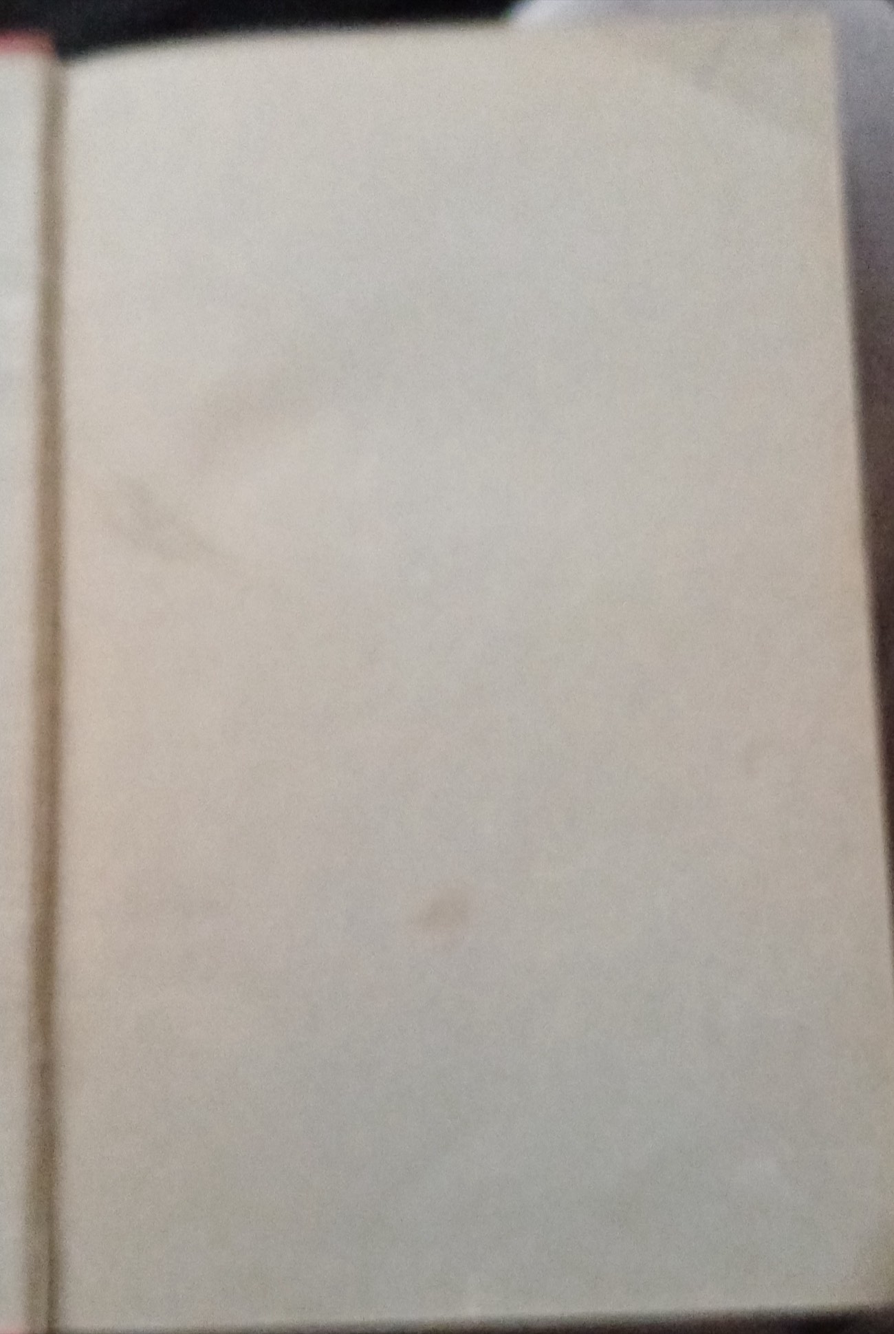 An antique book opened to a blank page